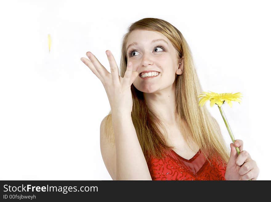 Attractive blond plukcing petals from a daisy. Attractive blond plukcing petals from a daisy