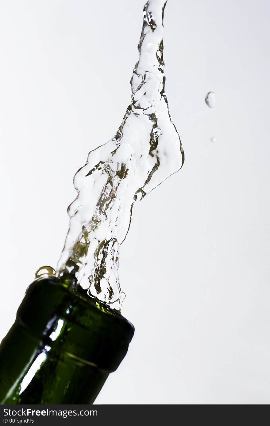 Pure water splashing from a green bottle. Pure water splashing from a green bottle