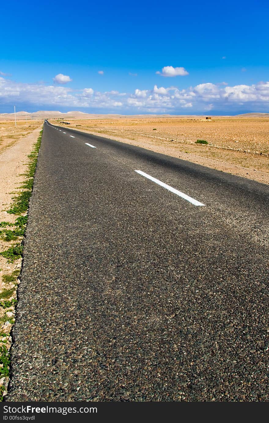 A road through the desertic landscape of Morocco. A road through the desertic landscape of Morocco