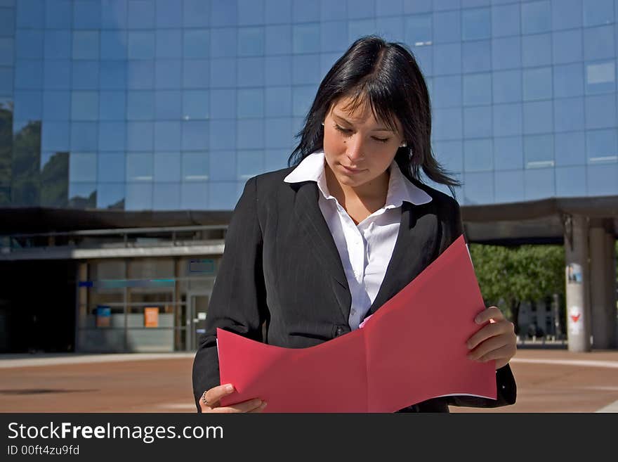 Businesswoman downtown reading a file