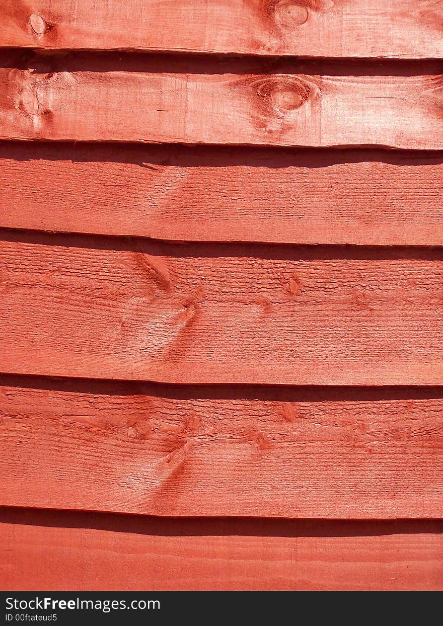 Close-up photo of a stained fence panel