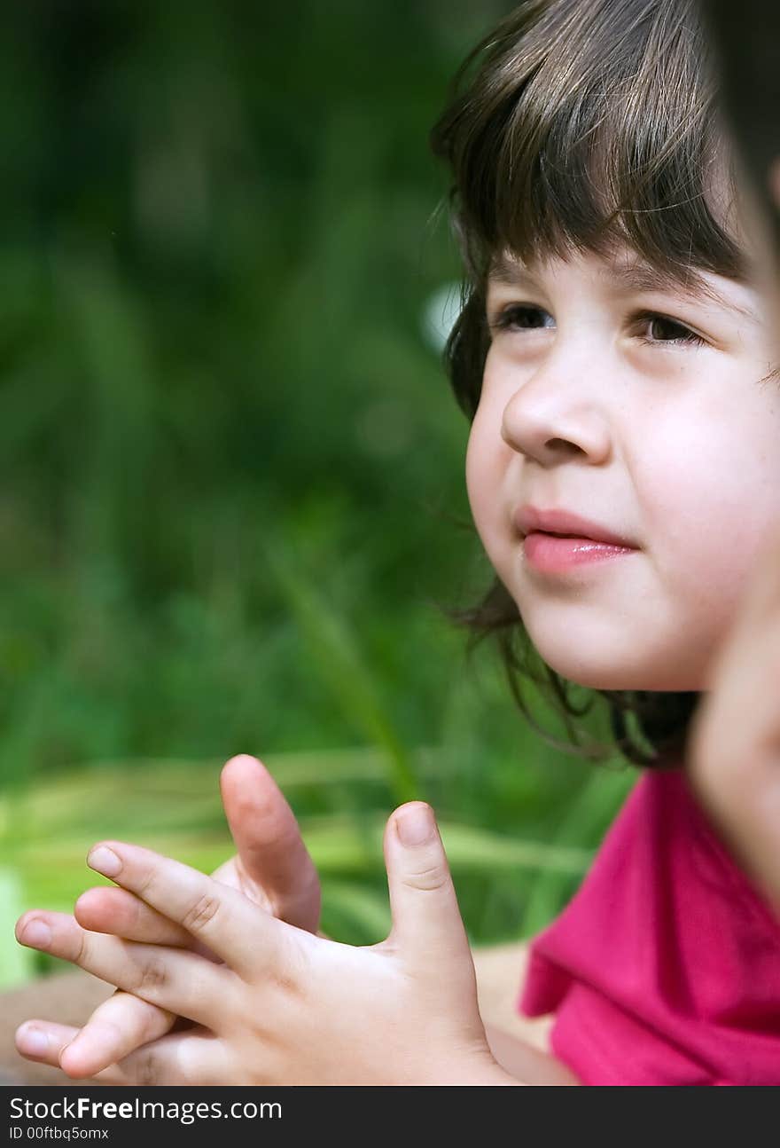 Little girl looking and listening to a little boy in the garden