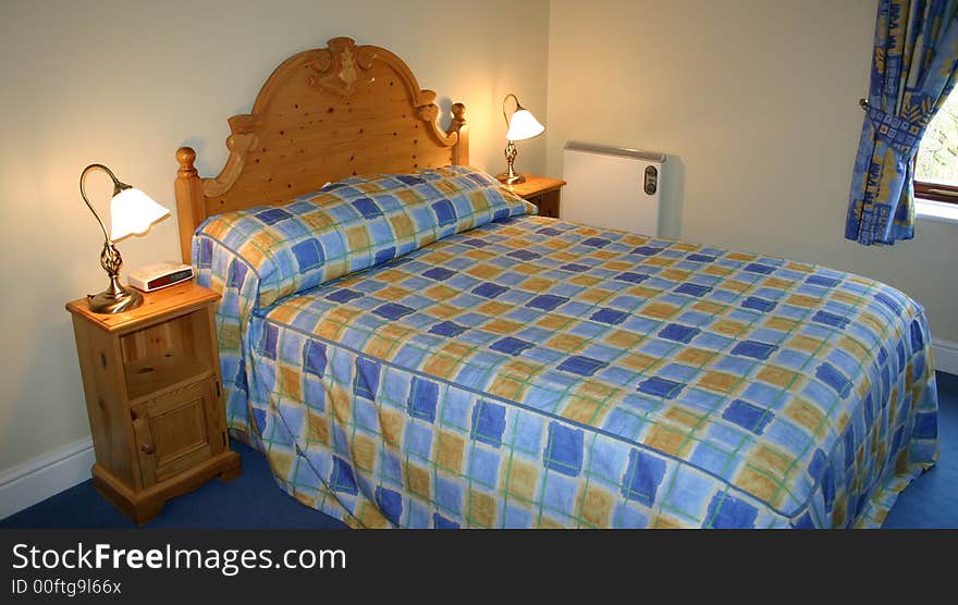 Bedroom interior with the bedside lamps turned on