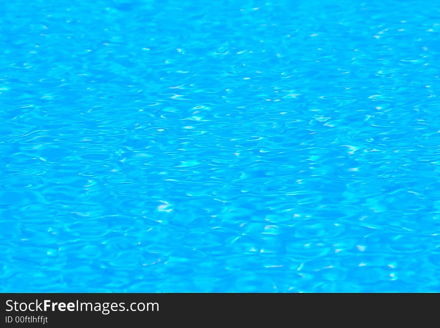 Water in a swimming pool taken at midday with a close-up lens to capture a small detail of the ripples on the surface created by a warm tropical wind. Taken with a Nikon D50 camera with 105mm macro lens. 1/250 sec at F16. Water in a swimming pool taken at midday with a close-up lens to capture a small detail of the ripples on the surface created by a warm tropical wind. Taken with a Nikon D50 camera with 105mm macro lens. 1/250 sec at F16.