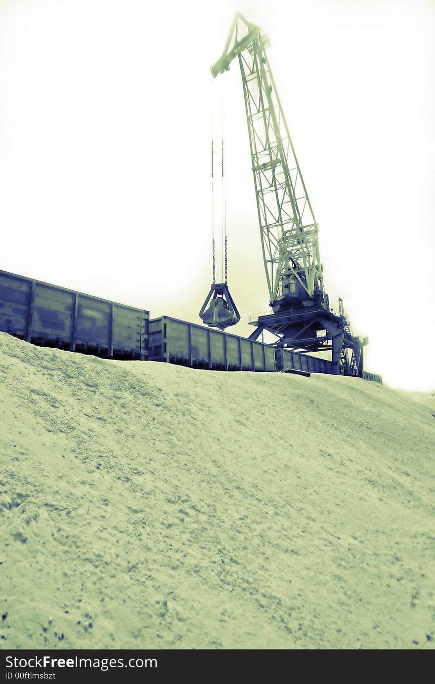 Loading of river sand by  port crane in railway cars. Loading of river sand by  port crane in railway cars