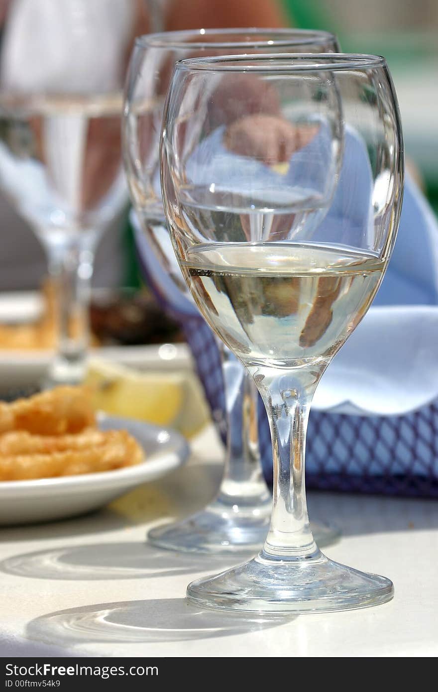 Diversity of fried fish on plate with glass of water. Diversity of fried fish on plate with glass of water