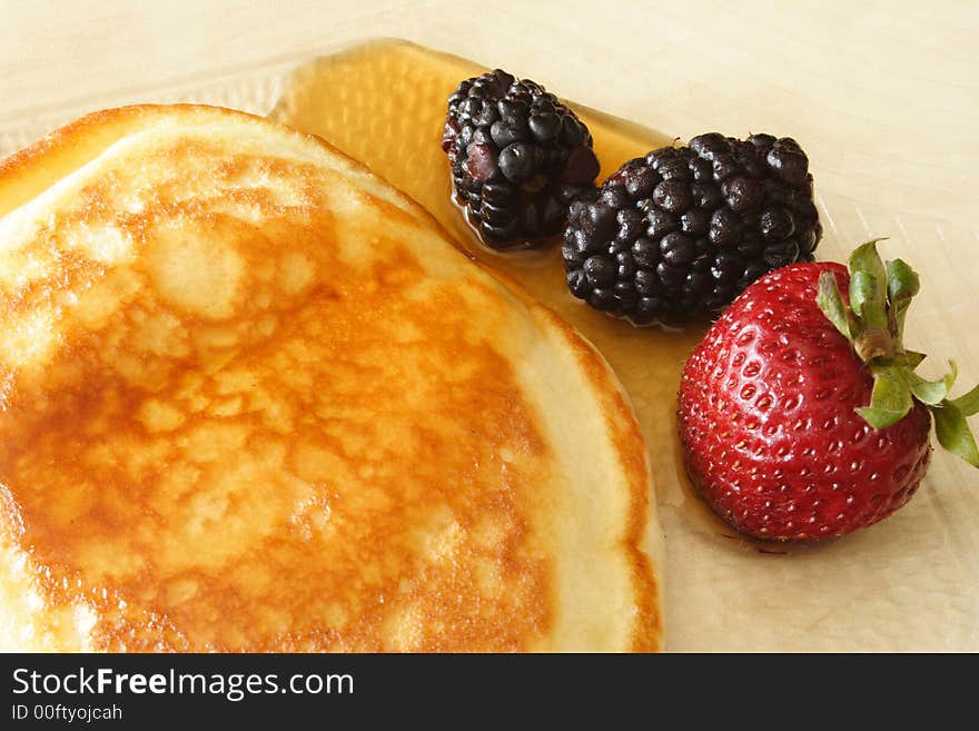 Pancake and red fruits with syrup. Pancake and red fruits with syrup