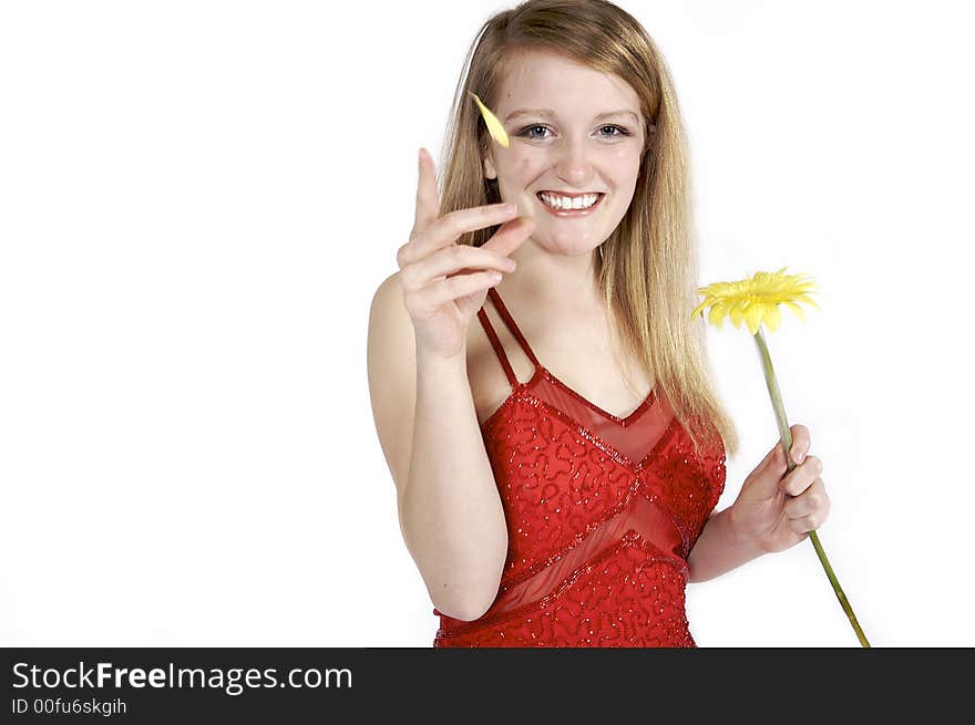 Attractive blond picking petals from a daisy. Attractive blond picking petals from a daisy