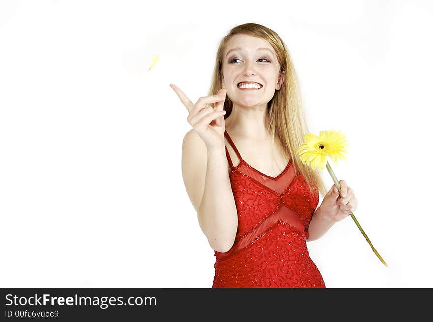 Attractive blond picking petals from a daisy. Attractive blond picking petals from a daisy