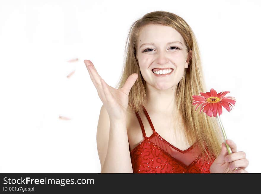 Attractive blond plucking petals from a daisy. Attractive blond plucking petals from a daisy