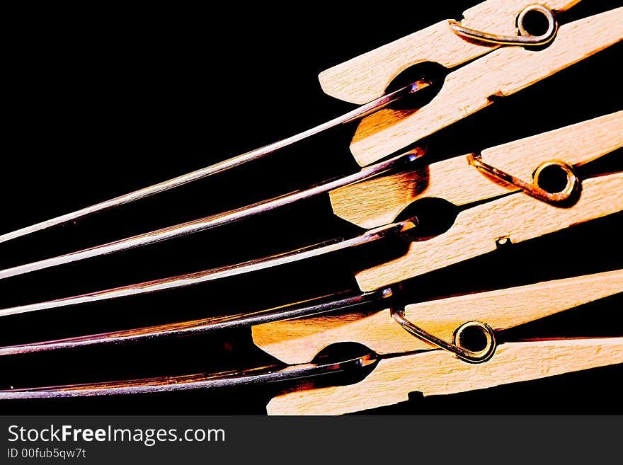 Linen wooden clips on spoons, (studio, halogen light). Linen wooden clips on spoons, (studio, halogen light).