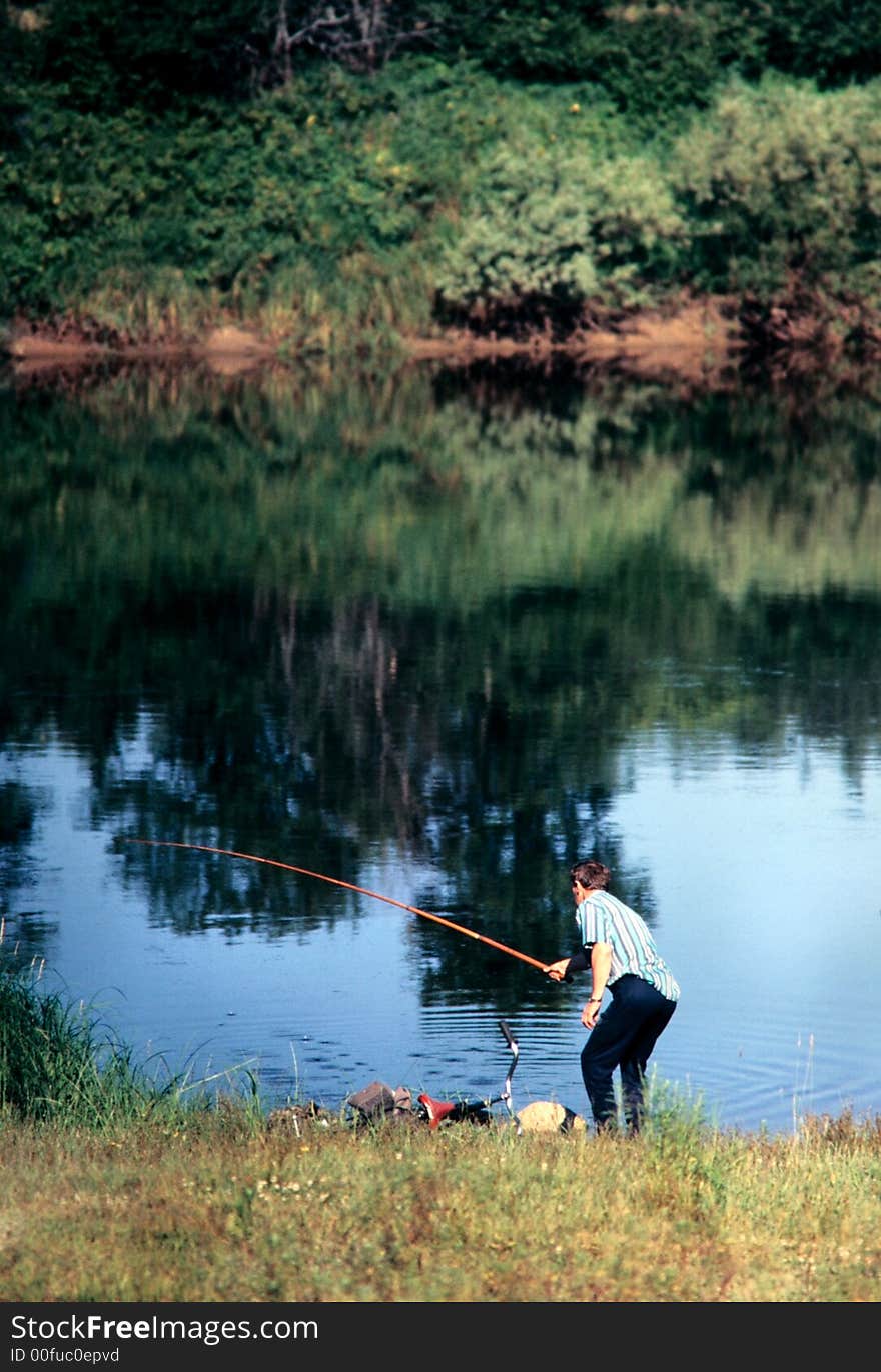 Summer sunny afternoon, river bank, fisherman, (lens - 135mm.; slide - 35mm.). Summer sunny afternoon, river bank, fisherman, (lens - 135mm.; slide - 35mm.).