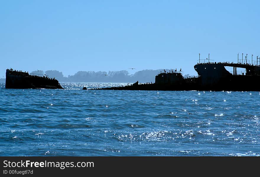 Submerged ship in silhouette at twilight. Submerged ship in silhouette at twilight