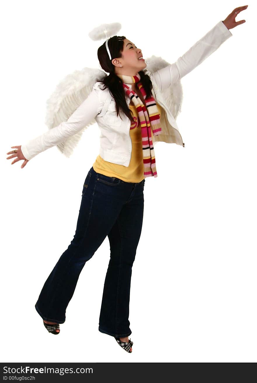 Isolated asian girl wearing angel wing flying over or trying to reach to above. Isolated asian girl wearing angel wing flying over or trying to reach to above