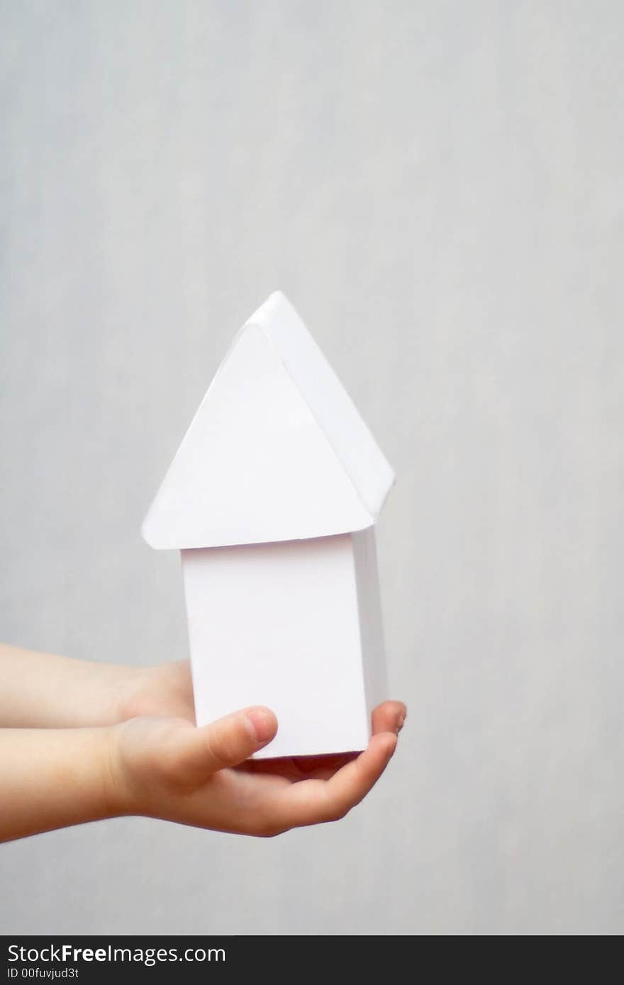 A model of a house in hands. A model of a house in hands