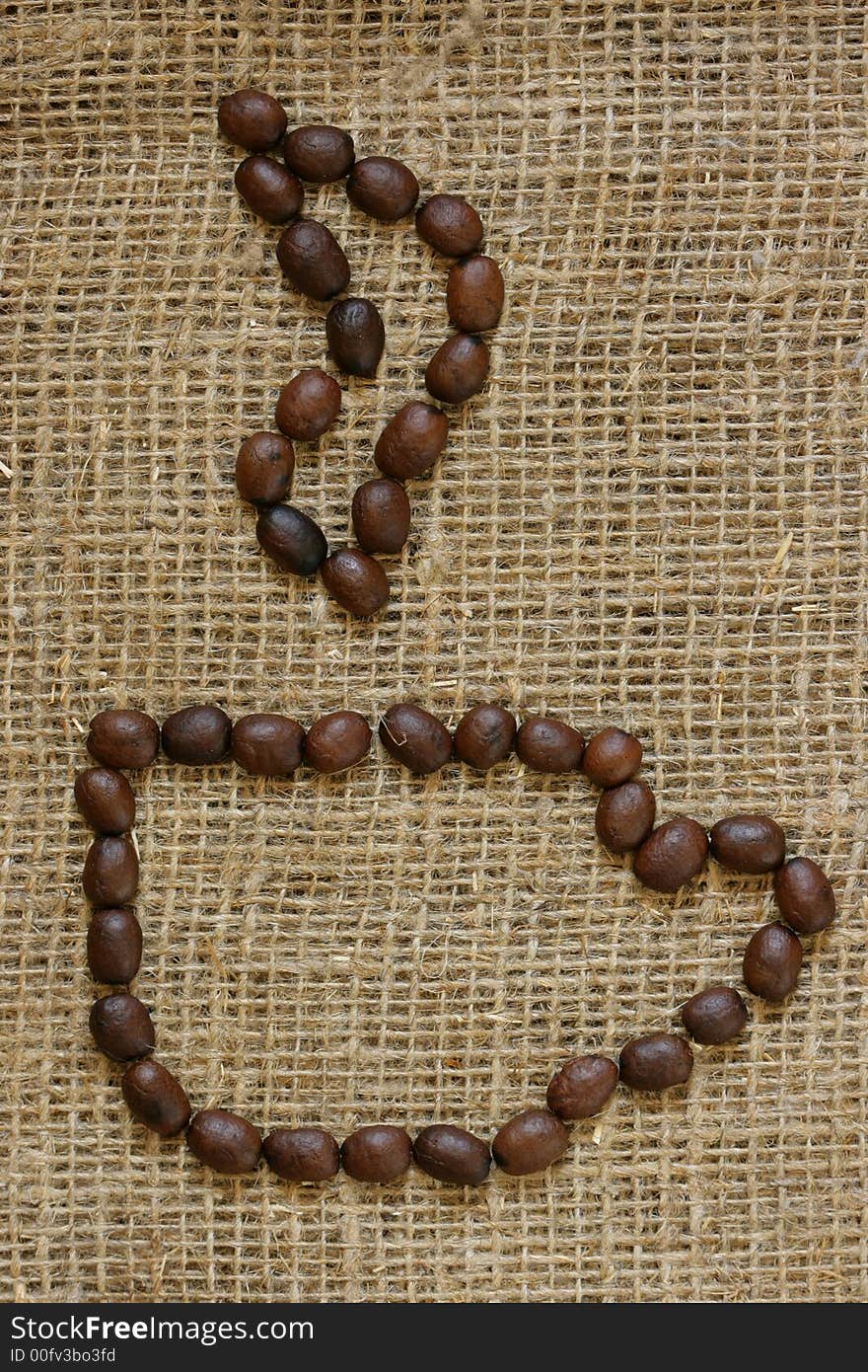 Contour of coffee cup made from coffee grains over burlap background