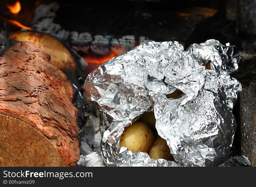 Roasting potatoes on outdoor barbecue grill. Roasting potatoes on outdoor barbecue grill