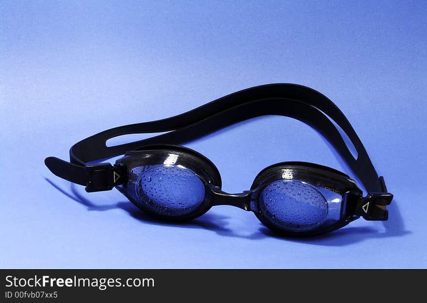 Swimming goggle on blue background. Swimming goggle on blue background