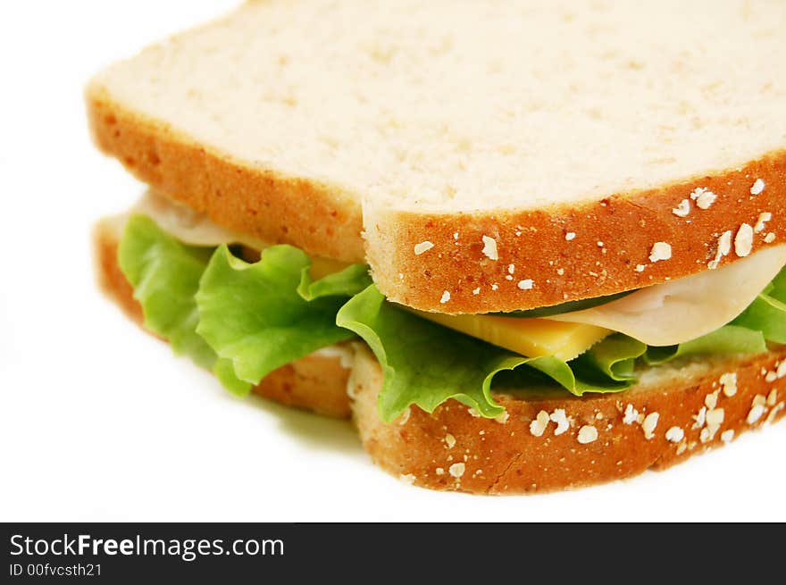 Turkey sandwich on whole wheat on a white background. Turkey sandwich on whole wheat on a white background