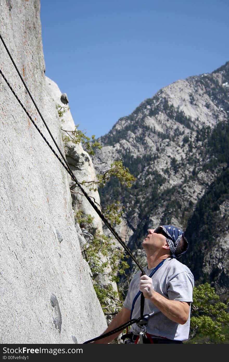 Rock climber checks rope