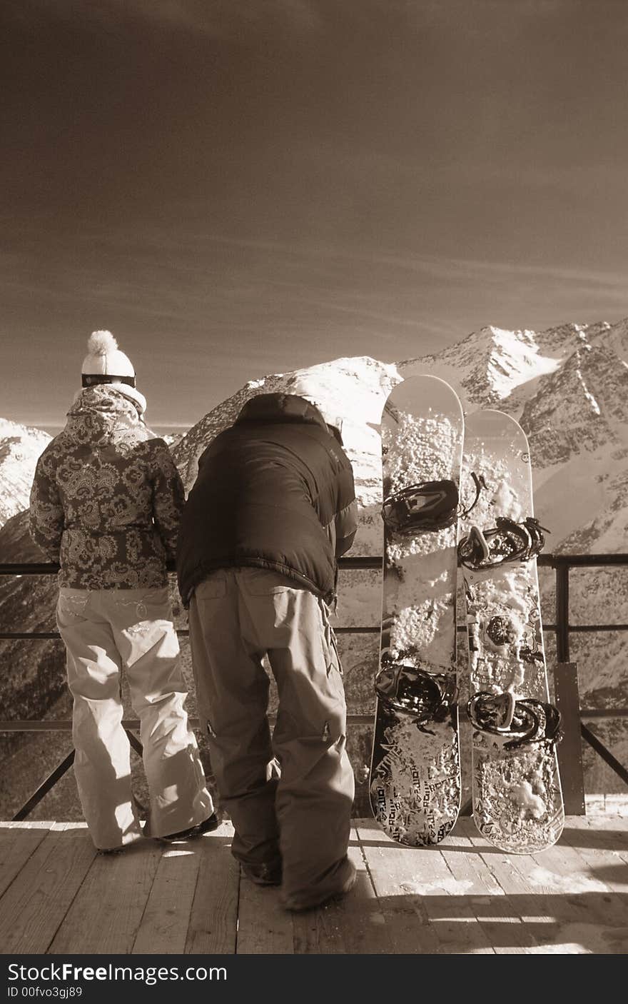 A couple of snowboarders seeing views. A couple of snowboarders seeing views