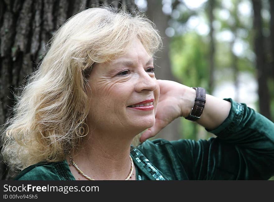 A pretty, mature blond woman in the park. A pretty, mature blond woman in the park.