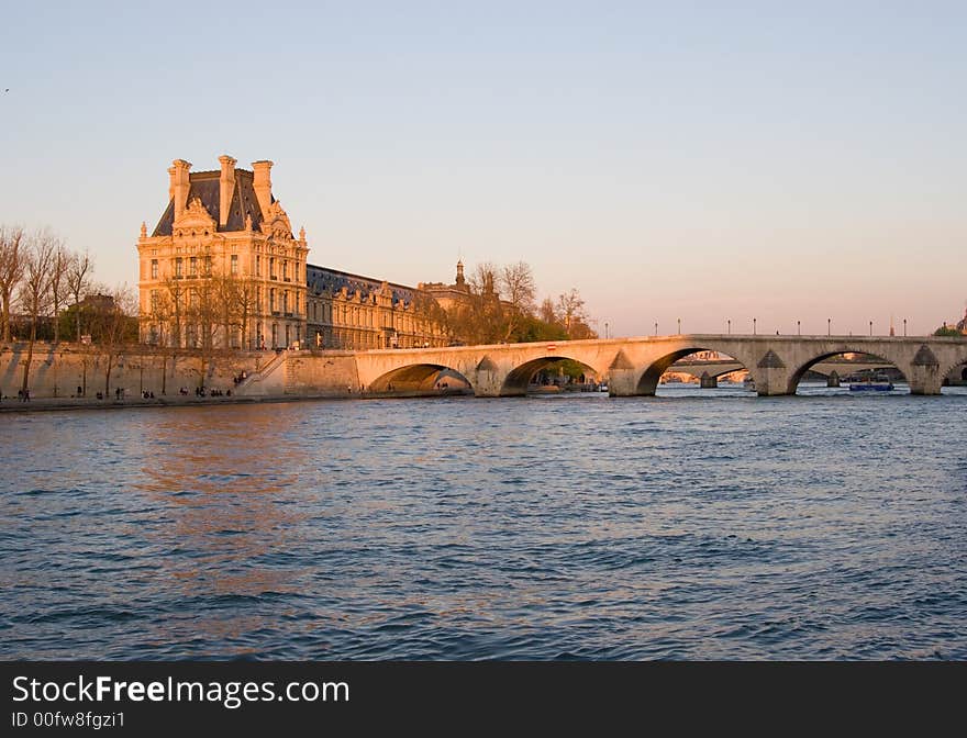 View of the Louvre Museum, across the Seine River, at sunset, Paris, France