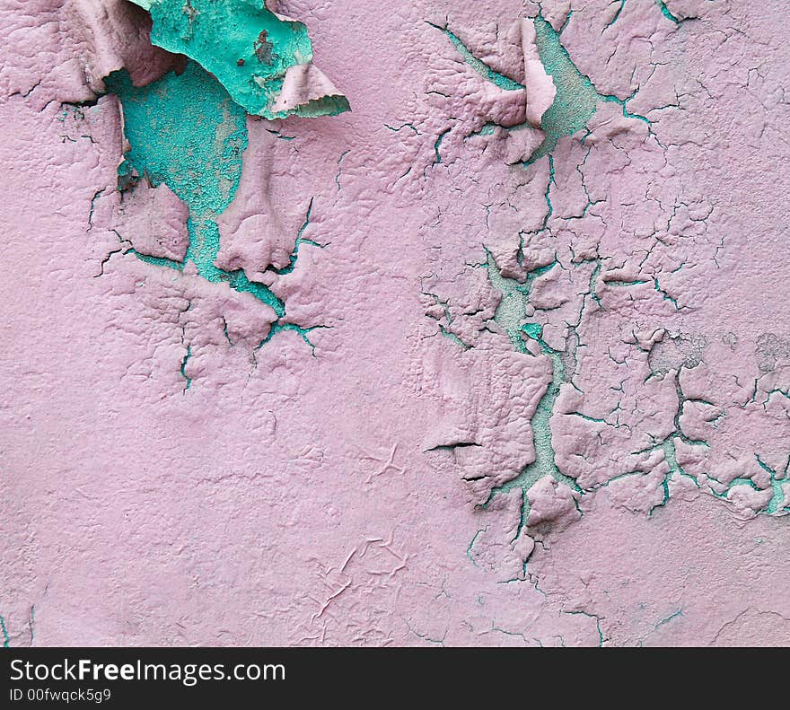 An old wall paint peeling off showing the old paint. An old wall paint peeling off showing the old paint