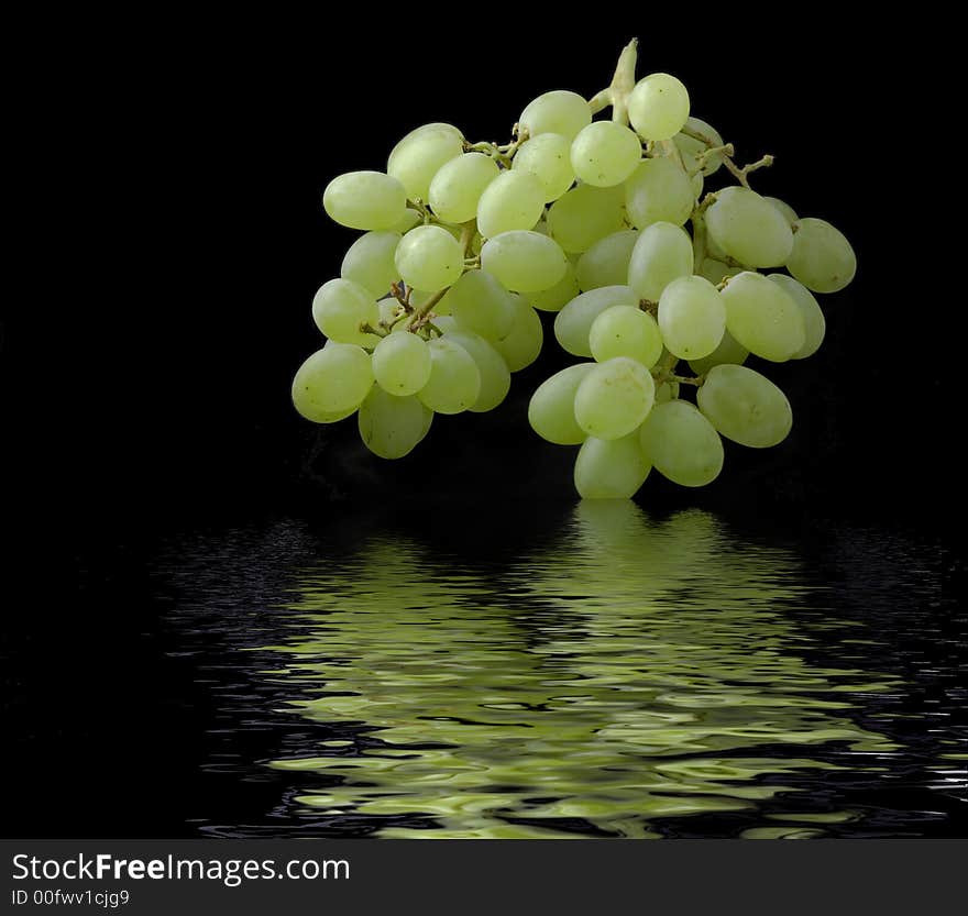 Green grapes with a water reflection on a black background. Green grapes with a water reflection on a black background