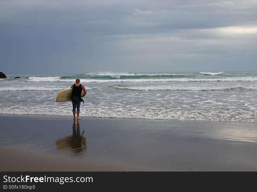 A lone surfer checking to see what the weather is like