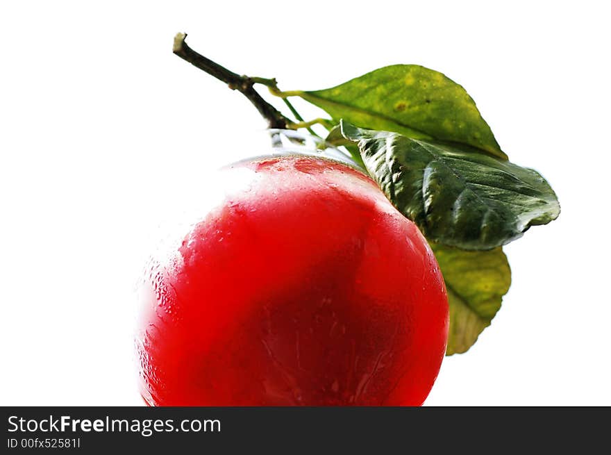 An isolated view of the bottom of a fresh strawberry drink with leaves on the side of the glass as garnish.