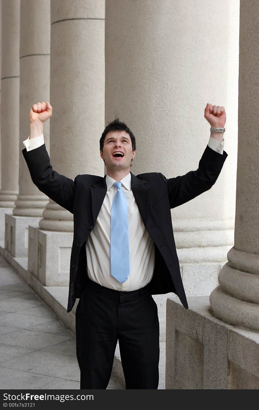 Young businessman throws his arms up in a gesture of success. Young businessman throws his arms up in a gesture of success.