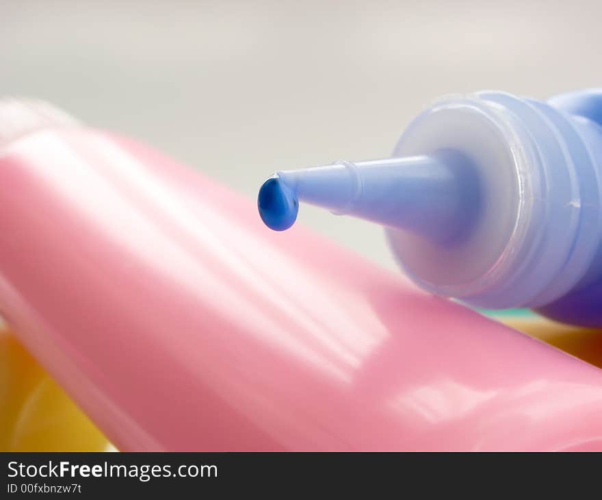 Tube of a blue paint with blue drop