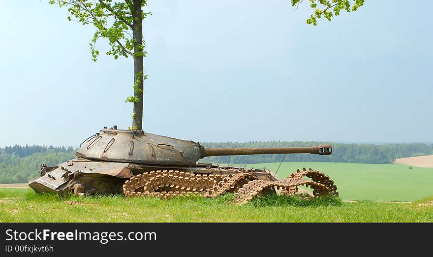 The old destroyed military self-propelled gun in a field. The old destroyed military self-propelled gun in a field