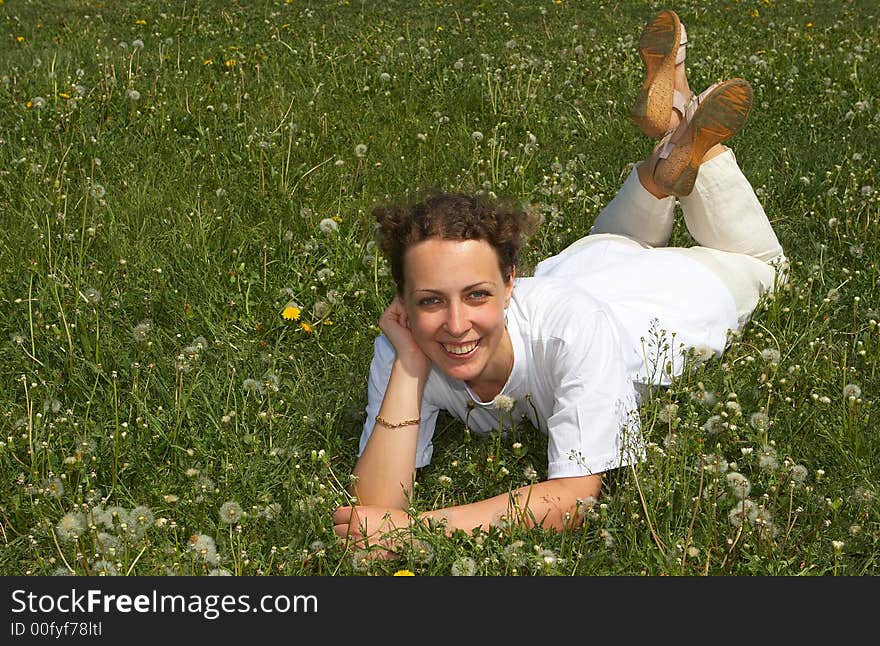 Young nice girl lays on a green grass. Young nice girl lays on a green grass