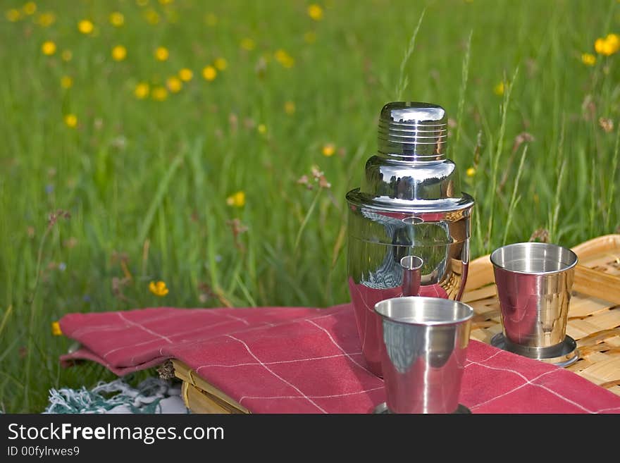 Basket of picnic in grass posed on a tablecloth