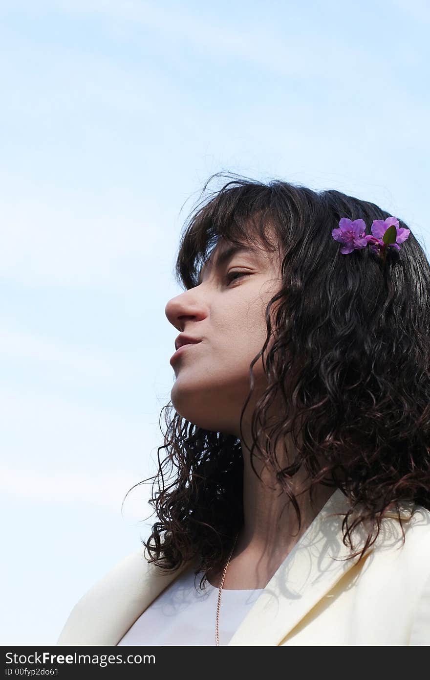 Haughty young women with flowers of labrador tea on hair