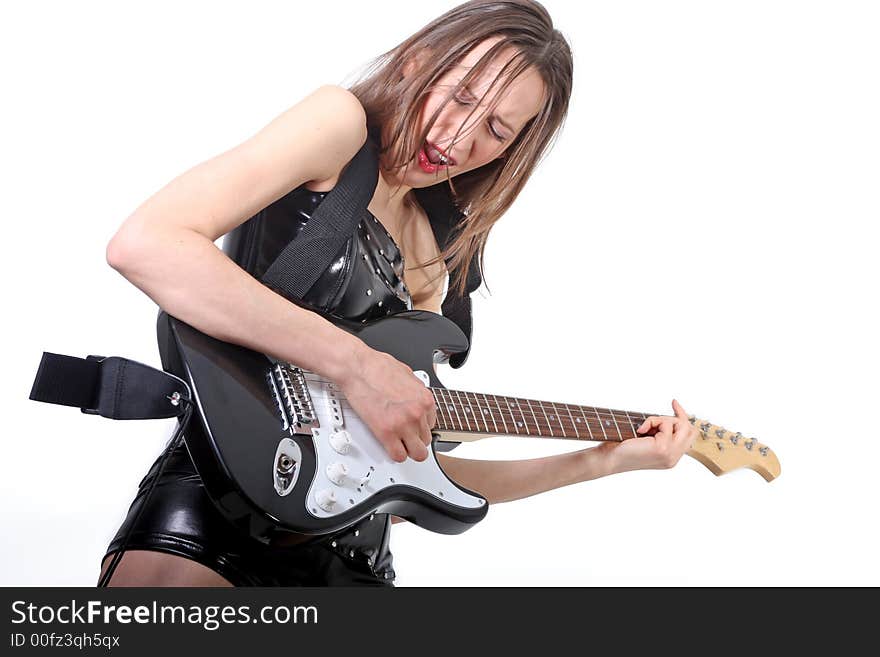 Beautiful brunette in leather with a black electric guitar. Beautiful brunette in leather with a black electric guitar