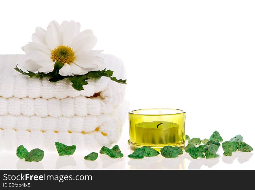 Towels, candle, and daisy on white isolated. Towels, candle, and daisy on white isolated