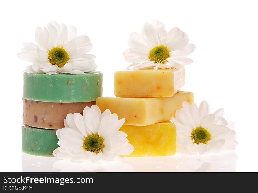 Soap bars and daisies isolated on white. Soap bars and daisies isolated on white