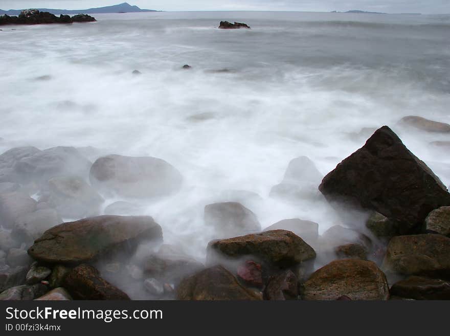 Waves breaking on rocks creating a dramatic effect. Waves breaking on rocks creating a dramatic effect