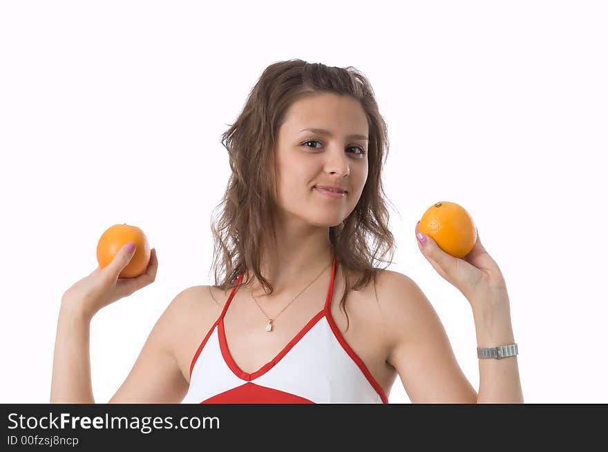 The brown-eyed girl on a white background holds oranges. The brown-eyed girl on a white background holds oranges