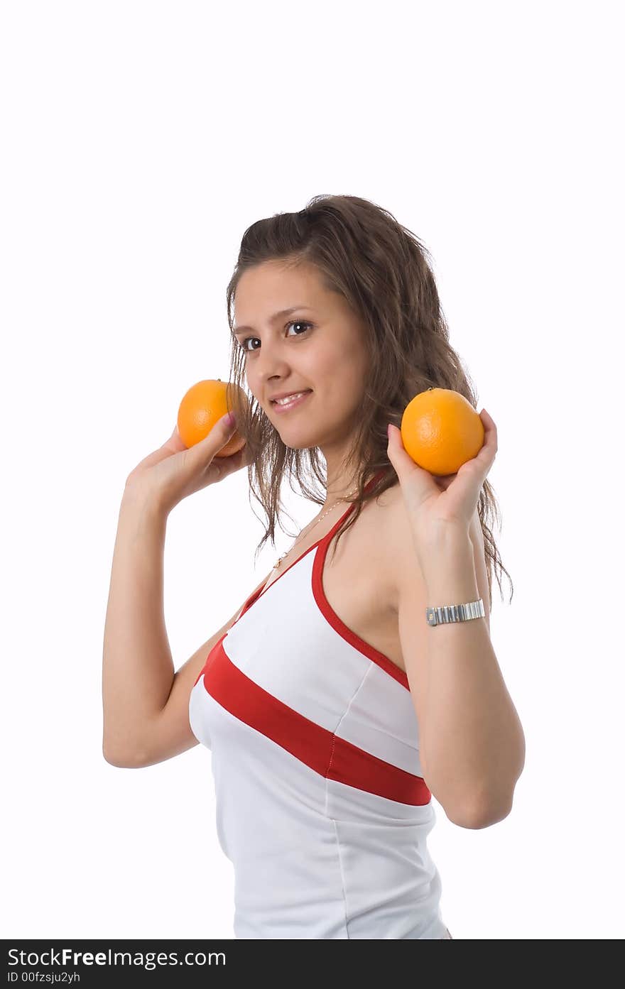 The brown-eyed girl on a white background holds oranges. The brown-eyed girl on a white background holds oranges