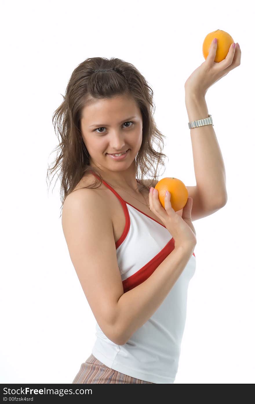 The brown-eyed girl on a white background holds oranges. The brown-eyed girl on a white background holds oranges