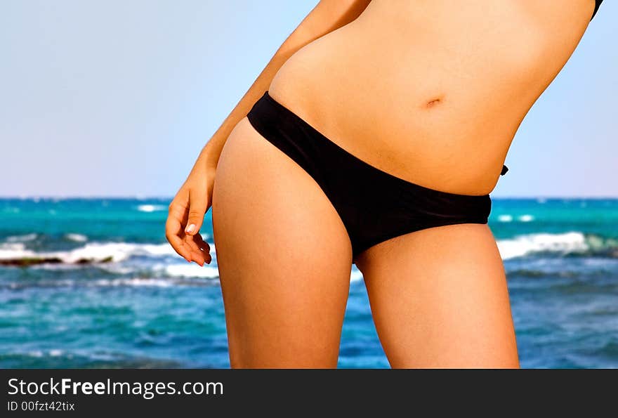 Woman standing in front of the sea. Woman standing in front of the sea