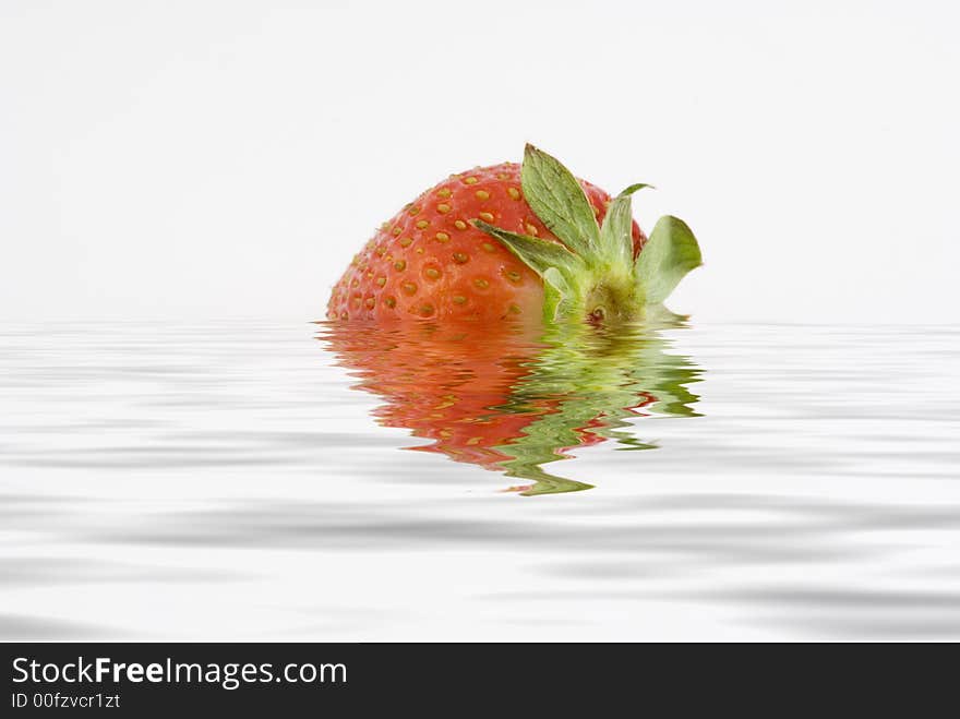 Strawberry isolated in a white background sorrounded by water. Strawberry isolated in a white background sorrounded by water