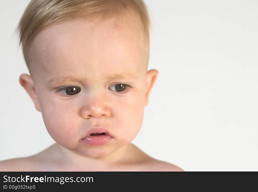 Image of beautiful toddler with a serious look on his face. Image of beautiful toddler with a serious look on his face