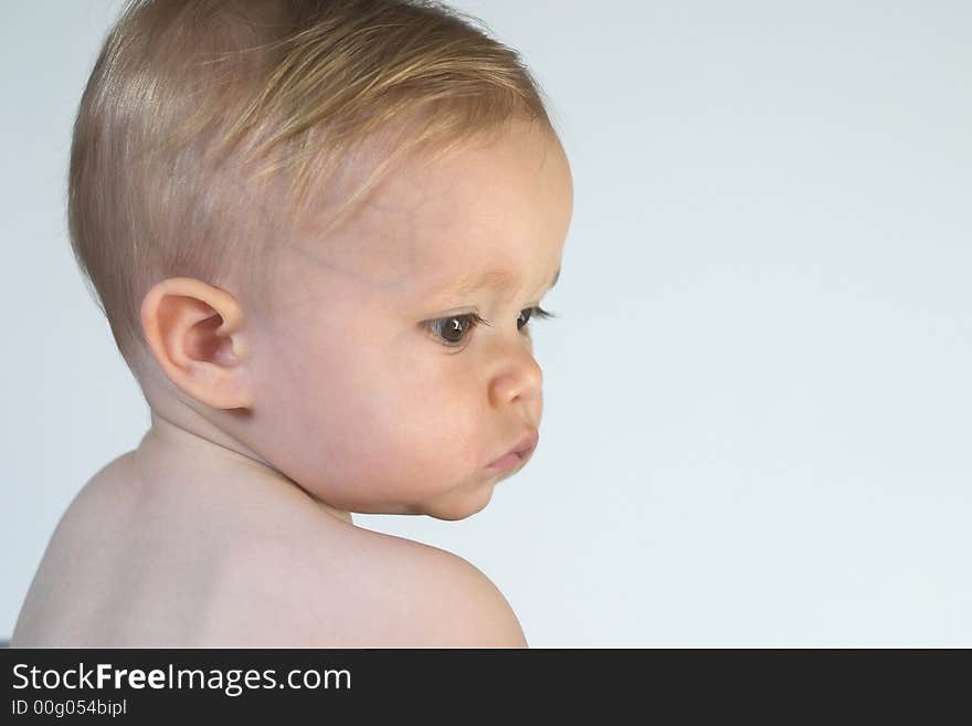 Image of beautiful toddler looking over his shoulder. Image of beautiful toddler looking over his shoulder