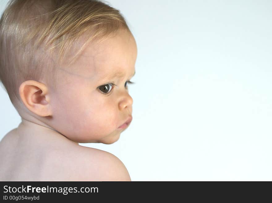 Image of beautiful toddler looking over his shoulder. Image of beautiful toddler looking over his shoulder