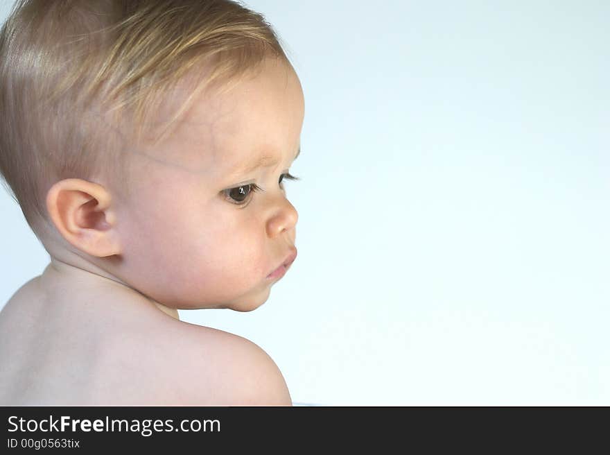 Image of beautiful toddler looking over his shoulder. Image of beautiful toddler looking over his shoulder